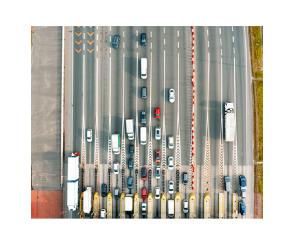 cars queuing across multiple lanes to pay road tolls
